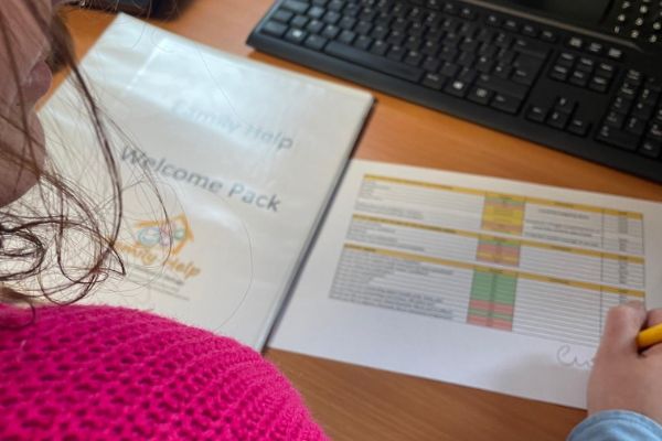 woman looking at paperwork at desk